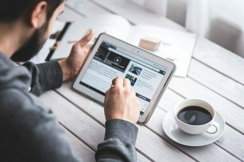 man with tablet and coffee