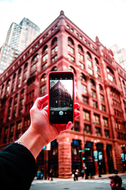 taking a picture of a building on a mobile phone