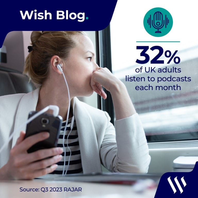 Woman on train with wired headphones plugged into mobile phone
